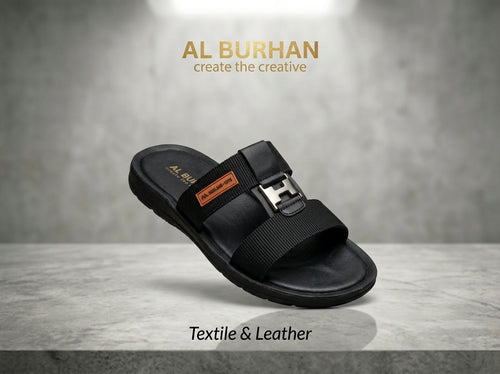 Black leather and textile slide sandal with H-shaped buckle on grey stone surface