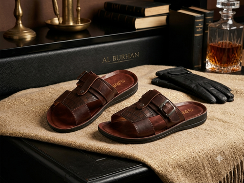 Pair of dark brown embossed leather slide sandals with silver buckles