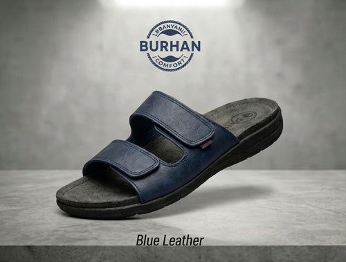 Navy blue leather slide sandal with two adjustable straps on grey stone surface